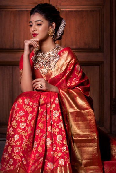 A Scarlet Symphony: Unveiling the Enduring Charm of Red Kanjivaram Silk Saree in a Bridal Trousseau